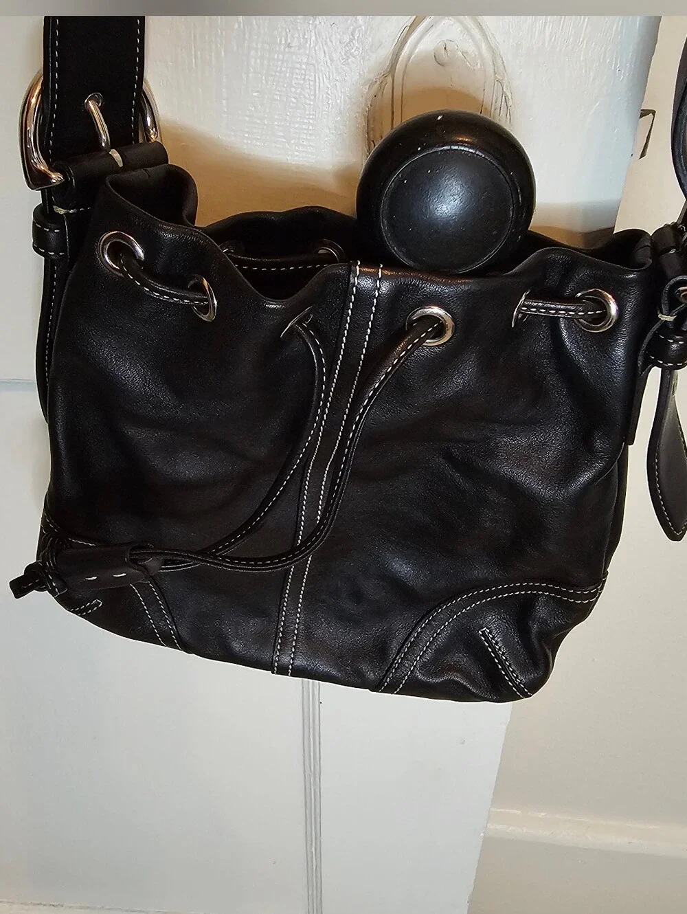 Coach Black leather crossbody bag with silver hardware and drawstring